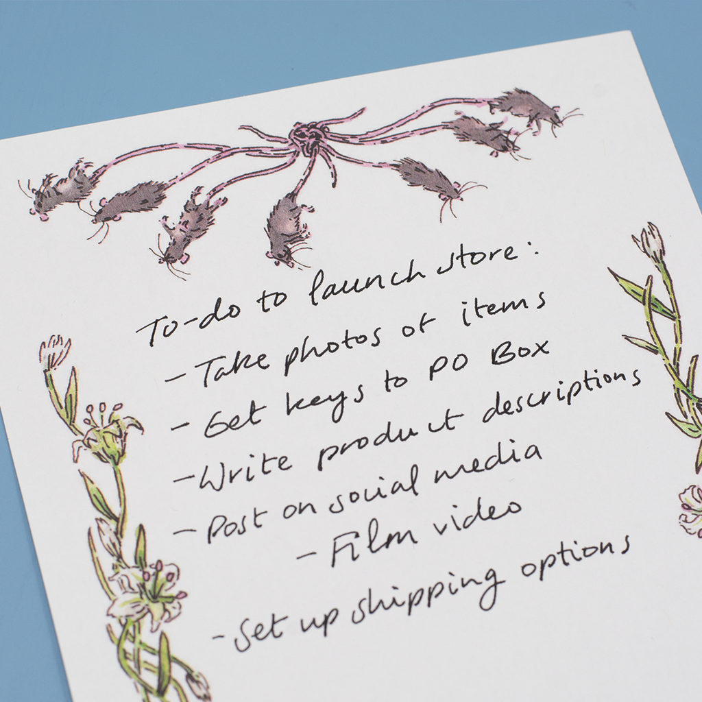 Close up detail of a page from the "Rat King Tearaway Notepad". The list handwritten on the page reads "To-do to launch store: take photos of items, get keys to PO box, write product descriptions, post on social media (film video), set up shipping options".